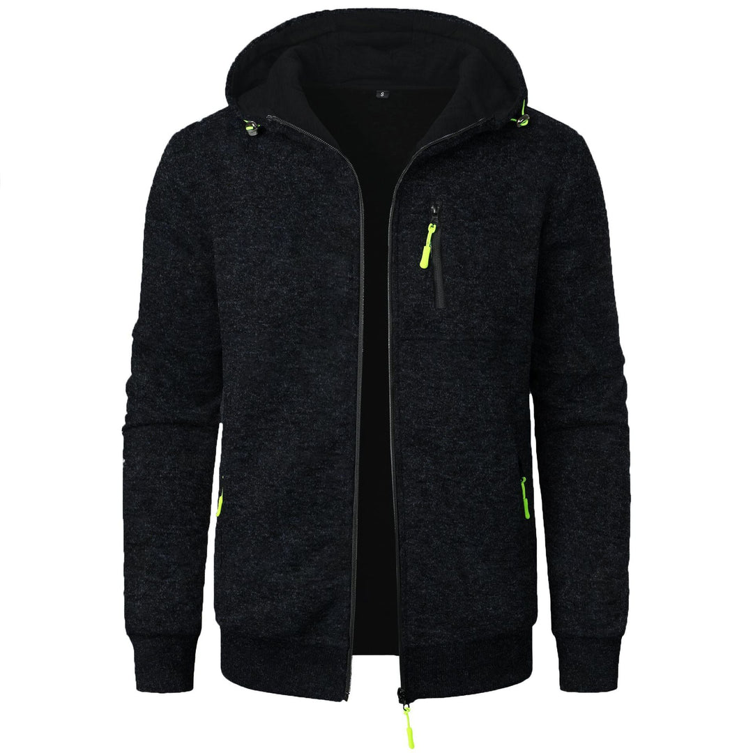 Felpa con cappuccio nera da uomo, zip frontale, tasche con cerniera verde fluorescente, design casual, ideale per abbigliamento sportivo e tempo libero.
