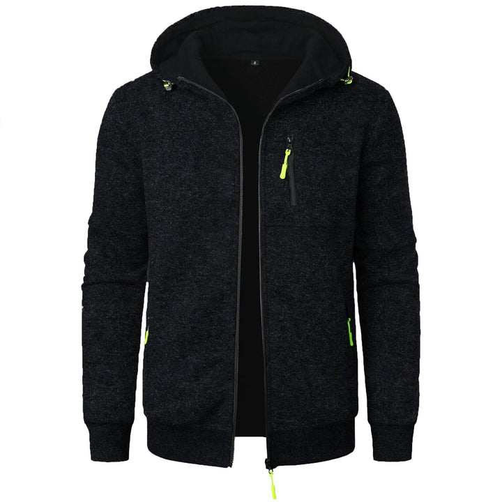 Felpa con cappuccio nera da uomo, zip frontale, tasche con cerniera verde fluorescente, design casual, ideale per abbigliamento sportivo e tempo libero.